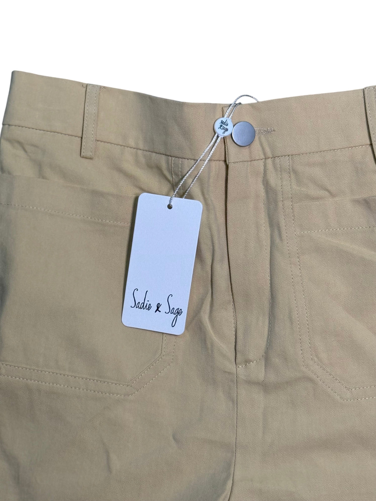 Yanet Collection Shop beige cotton trousers with Sadie & Sage brand tag attached to the waistband