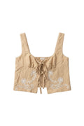 Yanet Collection Shop beige sleeveless crop top with white floral embroidery and a front tie closure.
