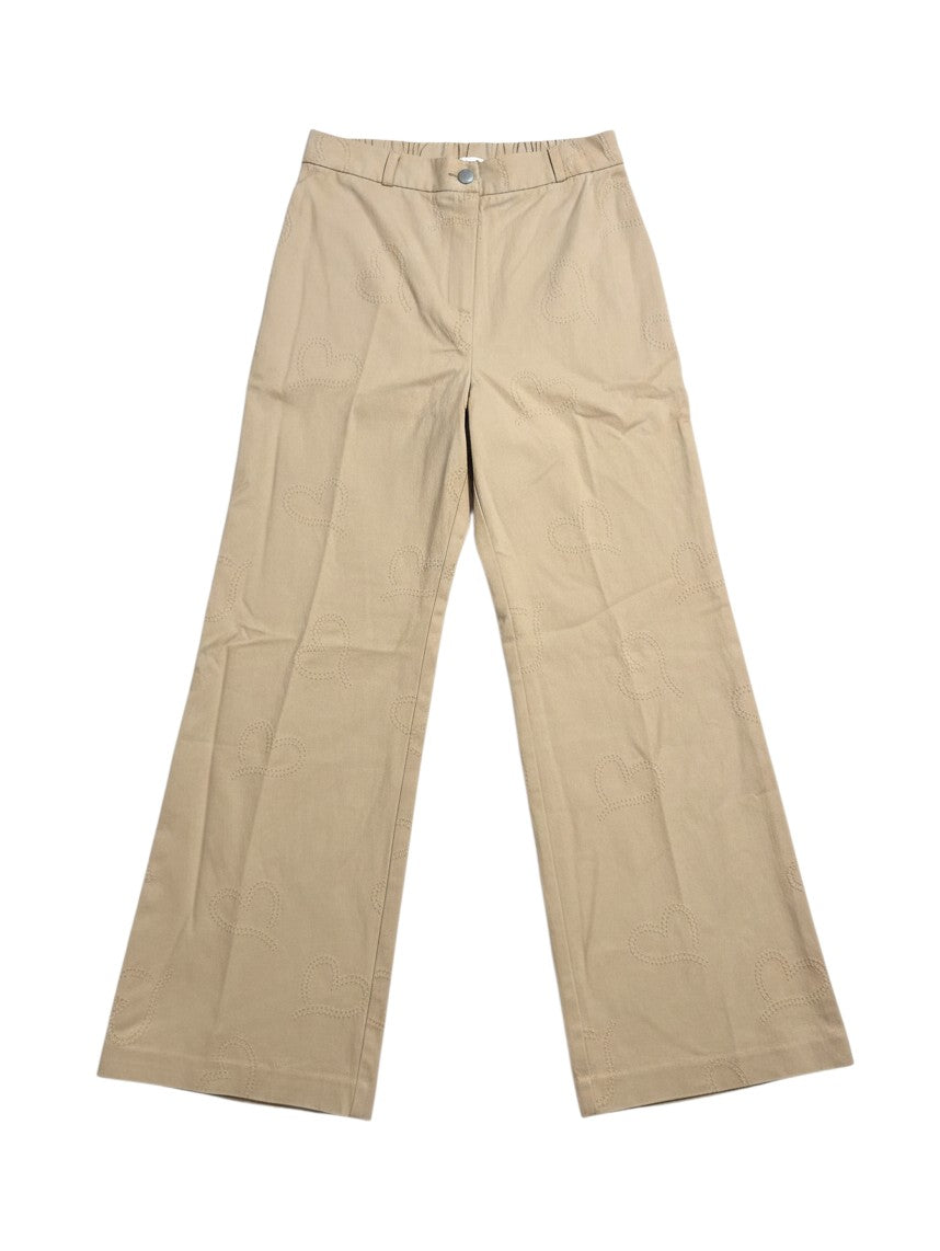 Yanet Collection Shop beige wide-leg trousers featuring a subtle heart pattern embroidery on a cotton fabric