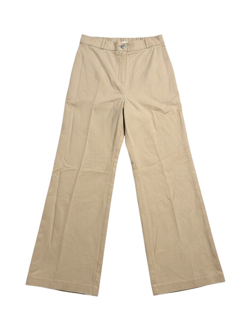 Yanet Collection Shop beige wide-leg trousers featuring a subtle heart pattern embroidery on a cotton fabric