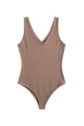 Yanet Collection Shop beige ribbed v-neck sleeveless bodysuit with a fitted silhouette and snap closure.