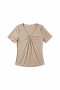 Yanet Collection Shop beige ribbed short sleeve top with a v-neckline and central ring detail.