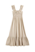 Yanet Collection Shop beige sleeveless maxi dress with a smocked bodice, ruffled straps, and a tiered hemline.