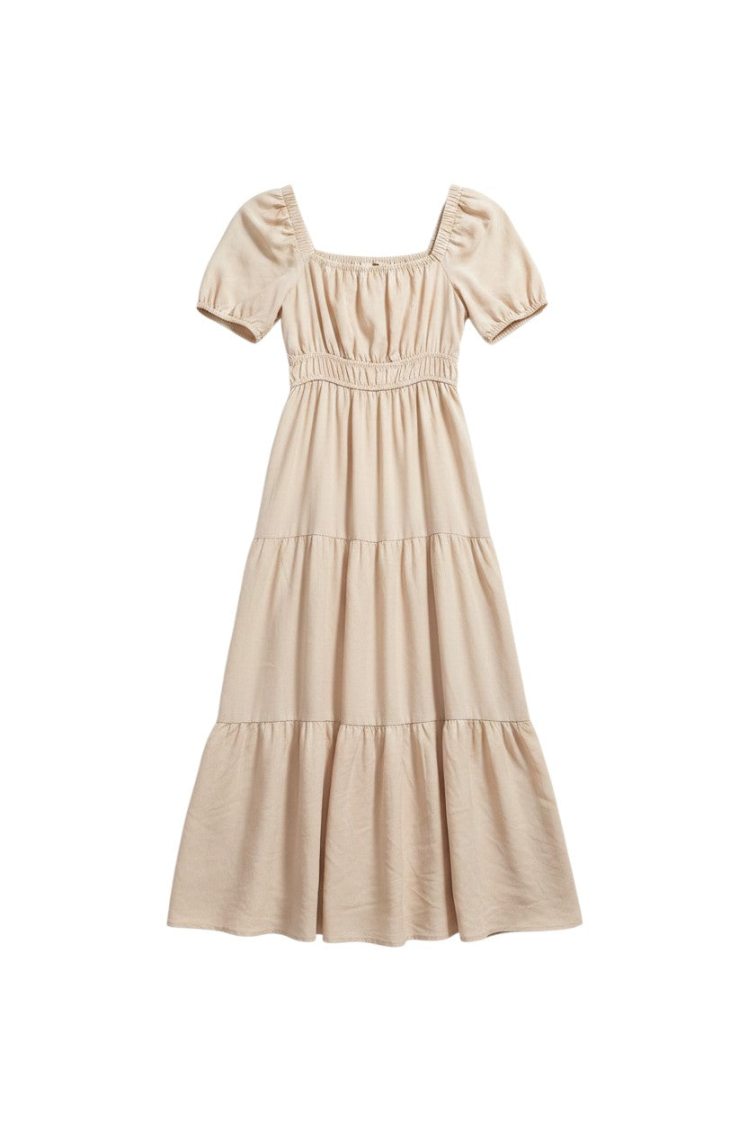 Yanet Collection Shop beige maxi dress with puff sleeves, square neckline, and a tiered flowy skirt.