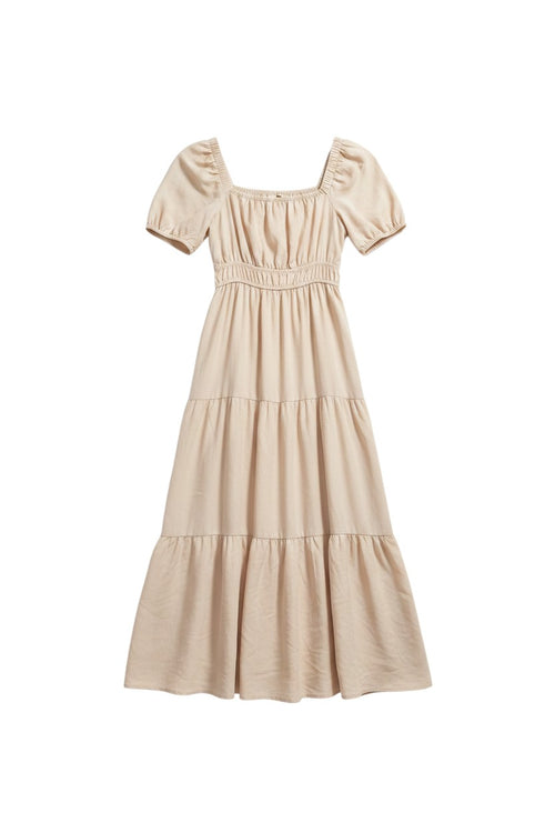 Yanet Collection Shop beige maxi dress with puff sleeves, square neckline, and a tiered flowy skirt.