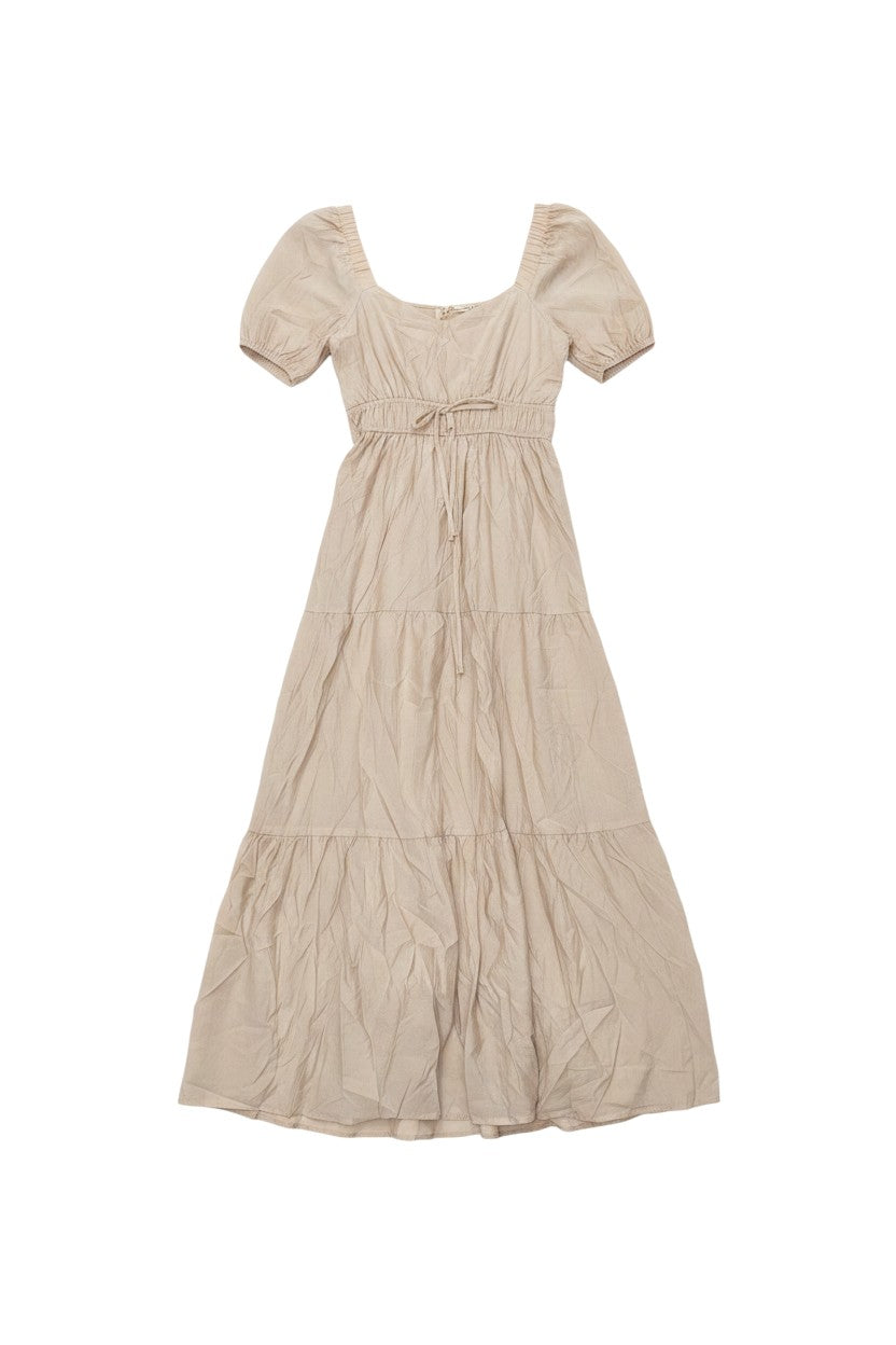 Yanet Collection Shop beige maxi dress with puff sleeves, square neckline, and a tiered flowy skirt.