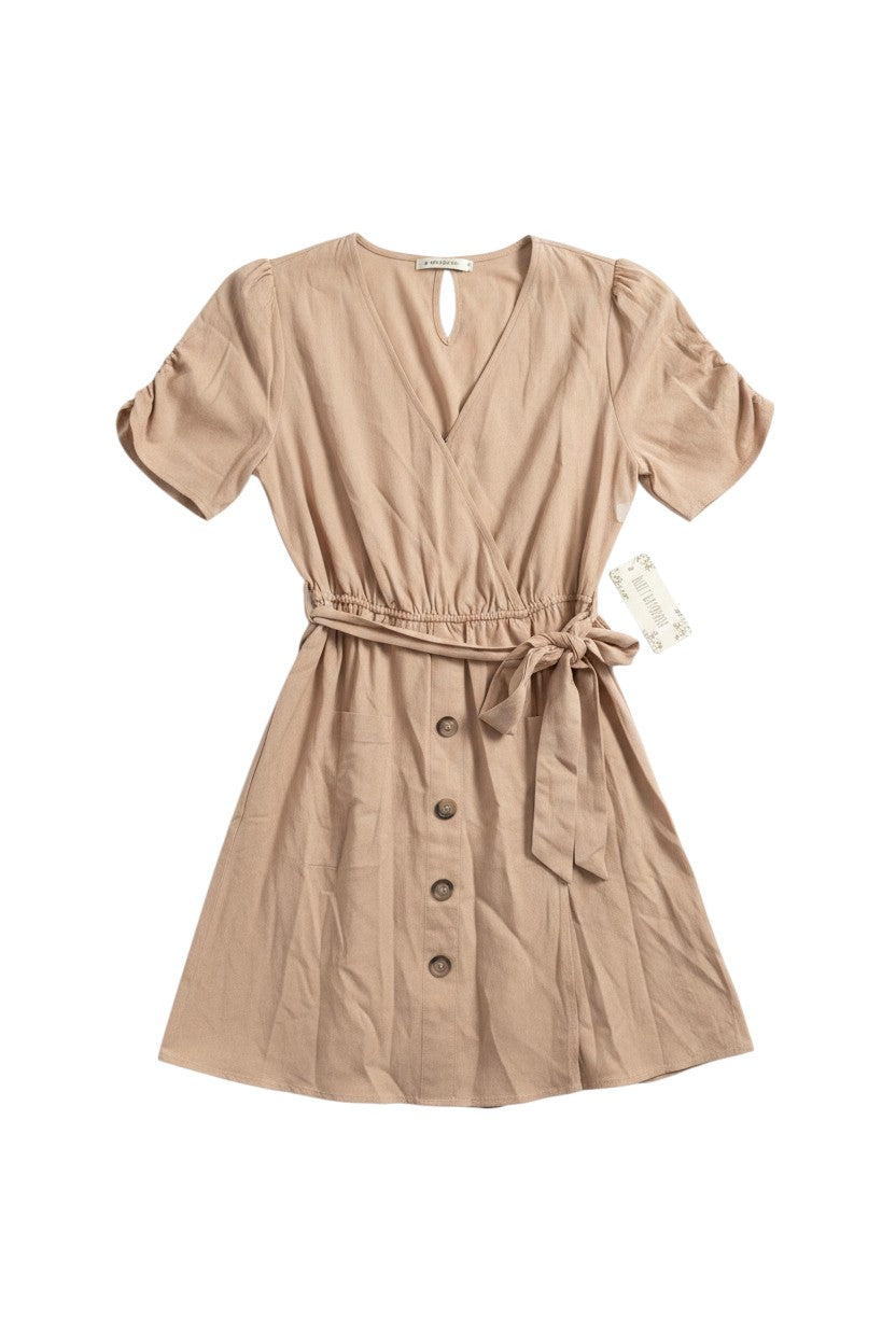 Yanet Collection Shop beige short sleeve wrap dress with a button-down front, cinched belted waist, and soft texture.