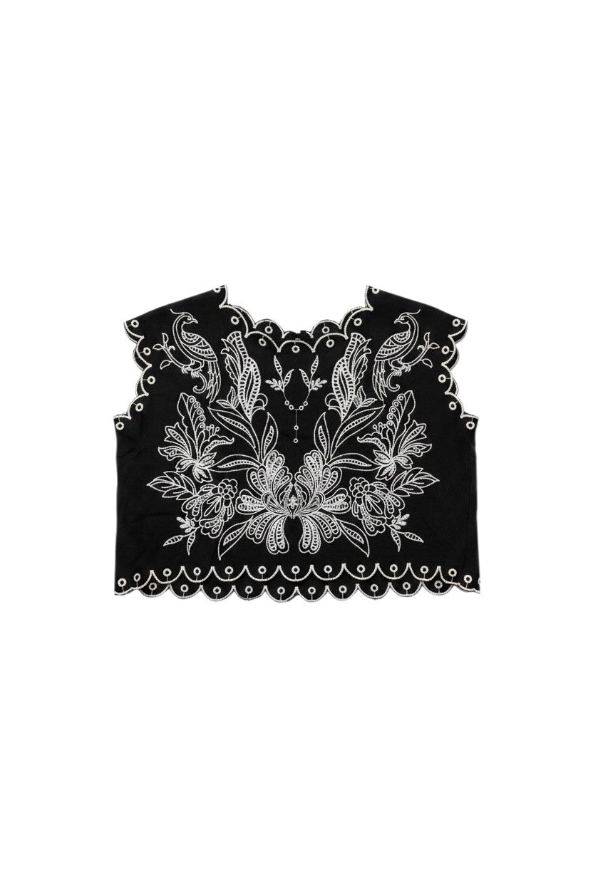 Yanet Collection Shop black sleeveless crop top with intricate white floral embroidery and a scalloped hemline.
