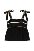 Yanet Collection Shop black spaghetti strap top with white wavy ruffled trim and adjustable tie shoulders.