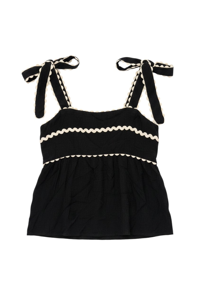 Yanet Collection Shop black spaghetti strap top with white wavy ruffled trim and adjustable tie shoulders.