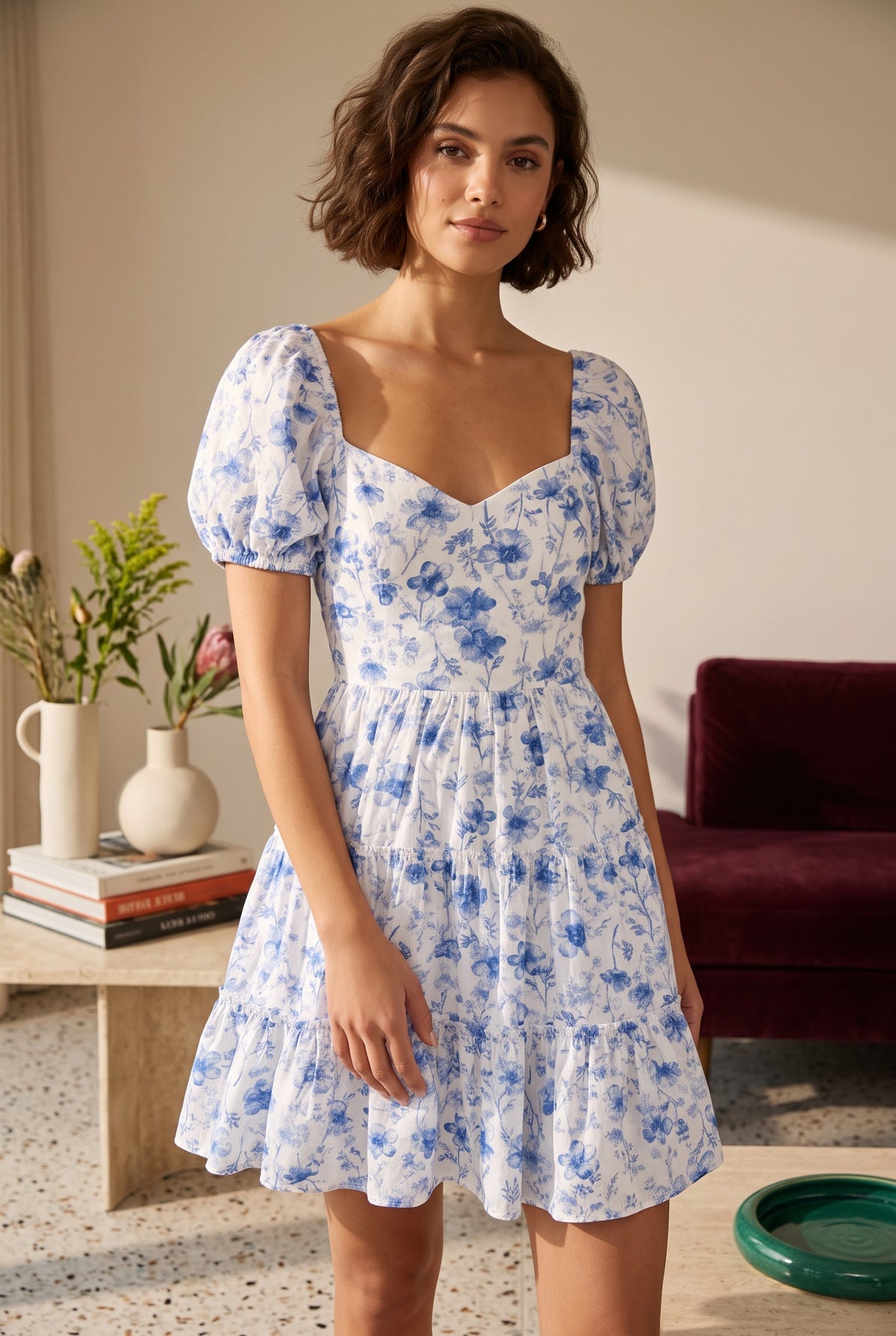 Yanet Collection Shop blue and white floral print mini dress with short puff sleeves and a sweetheart neckline.