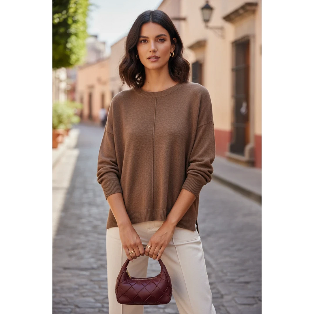Yanet Collection Shop brown long sleeve sweater with a relaxed fit and ribbed hem worn by a woman on a city street