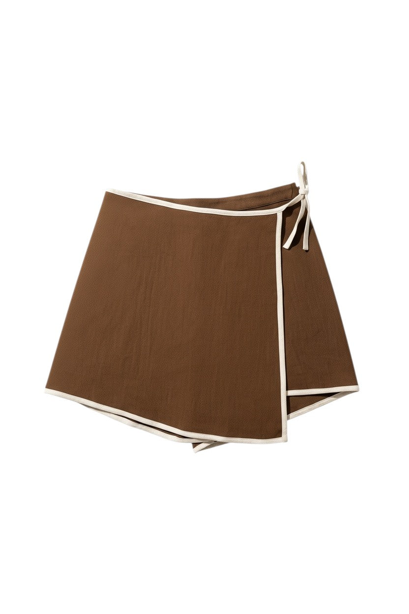 Yanet Collection Shop brown wrap-style shorts with white contrast trim and side tie closure in lightweight fabric