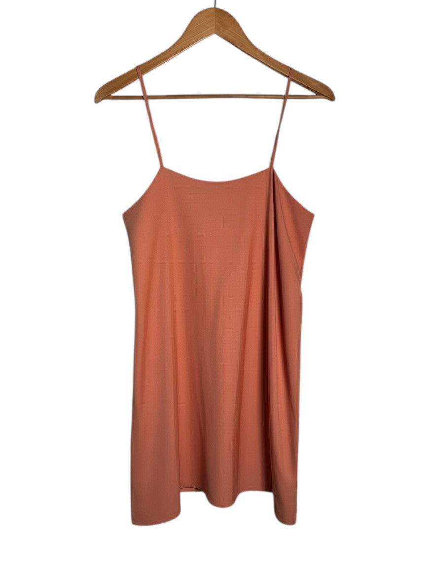 Yanet Collection Shop coral pink spaghetti strap mini dress with a textured fabric finish on a wooden hanger