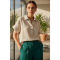 Yanet Collection Shop cream short sleeve button-up top with a classic collar worn by a woman in a sunlit room