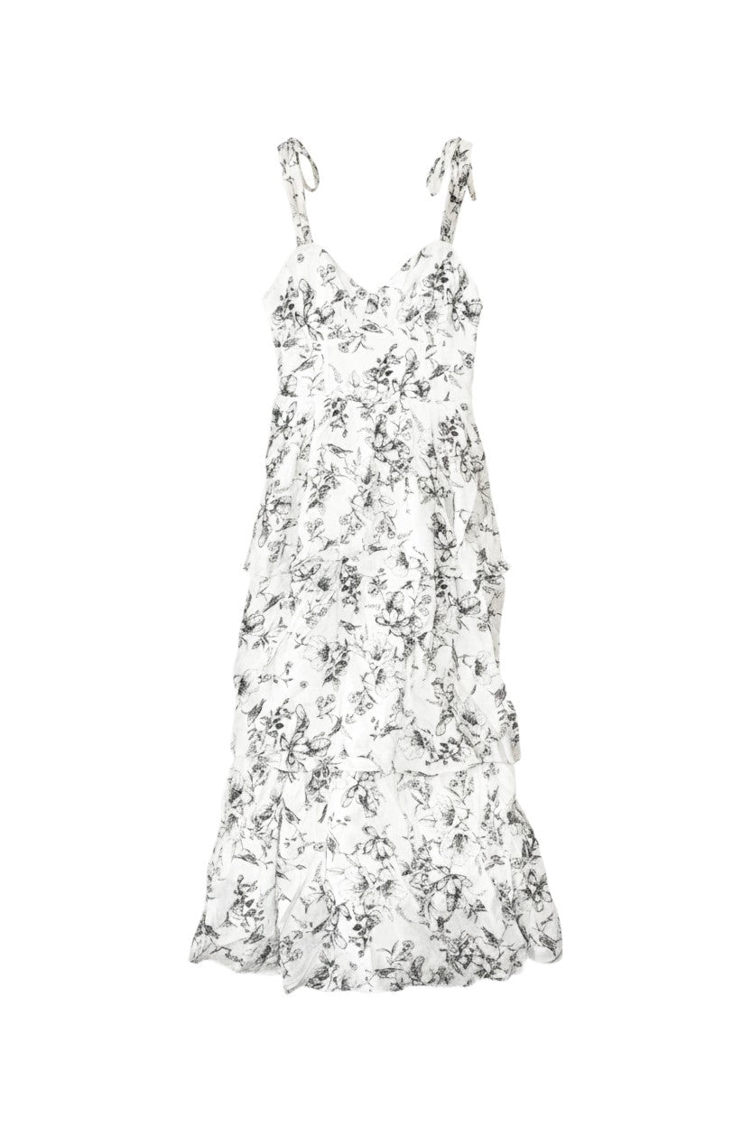 Yanet Collection Shop cream maxi dress with black floral print, ruffled layers, sweetheart neckline, and tie straps.