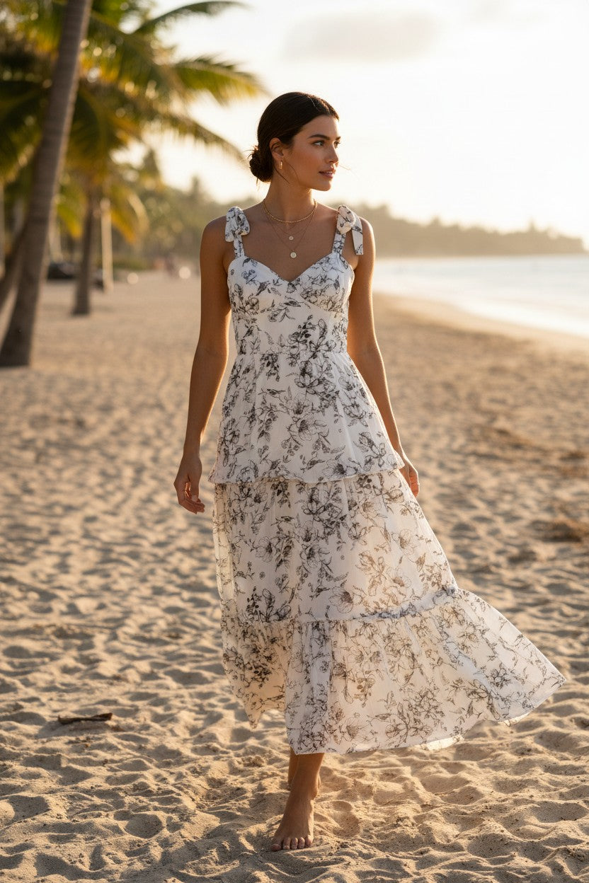 Yanet Collection Shop cream floral maxi dress with ruffled layers, sweetheart neckline, and spaghetti straps on beach