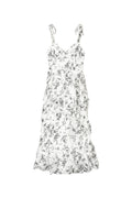 Yanet Collection Shop cream maxi dress with black floral print, ruffled layers, sweetheart neckline, and tie straps.