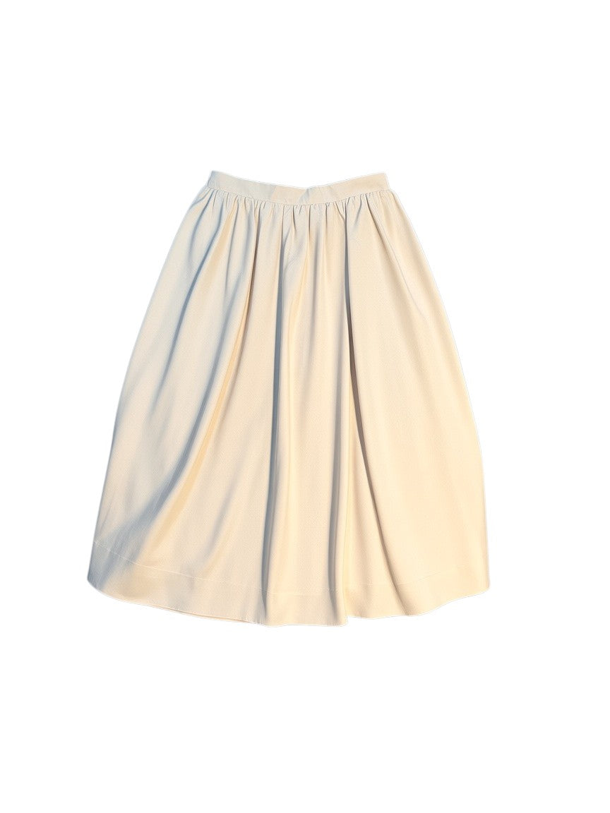 Yanet Collection Shop cream-colored A-line midi skirt with a structured waistband and soft pleated fabric.