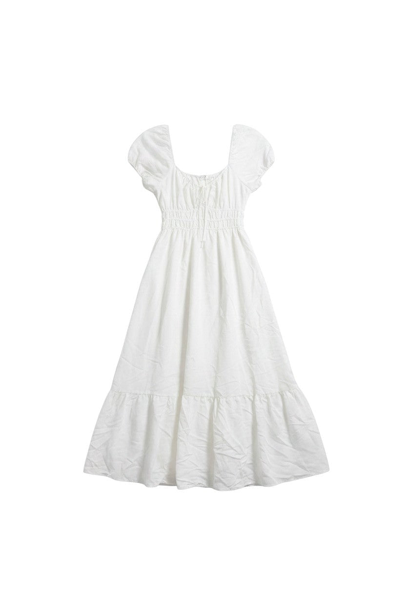 Yanet Collection Shop cream maxi dress with puff sleeves, smocked bodice, and a ruffled hem in lightweight fabric.