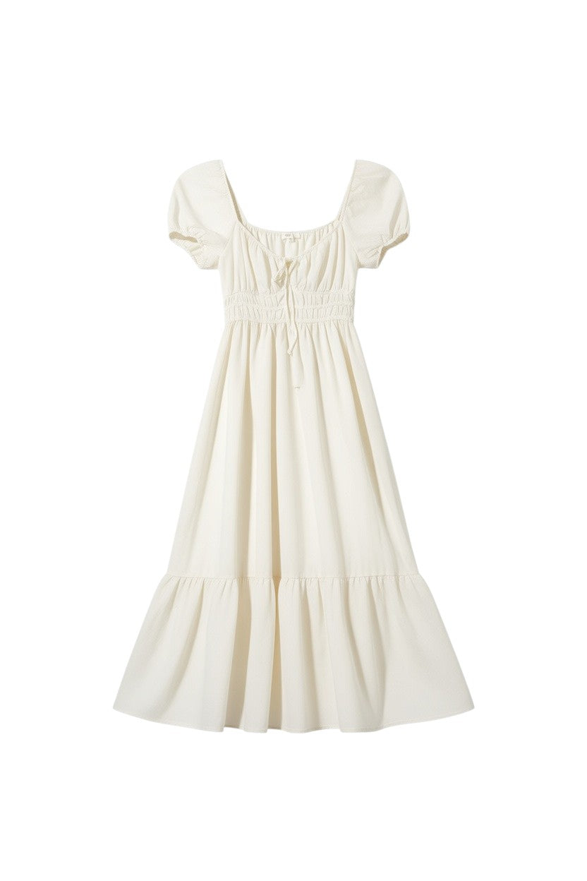 Yanet Collection Shop cream maxi dress with puff sleeves, smocked waist, and a flowy tiered skirt.