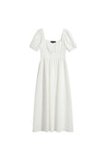 Yanet Collection Shop cream maxi dress with short puff sleeves and a smocked bodice in a lightweight draped fabric.