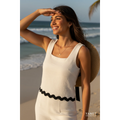 Yanet Collection Shop cream textured square neck crop top with a scalloped hem worn by a woman on a sunny beach.