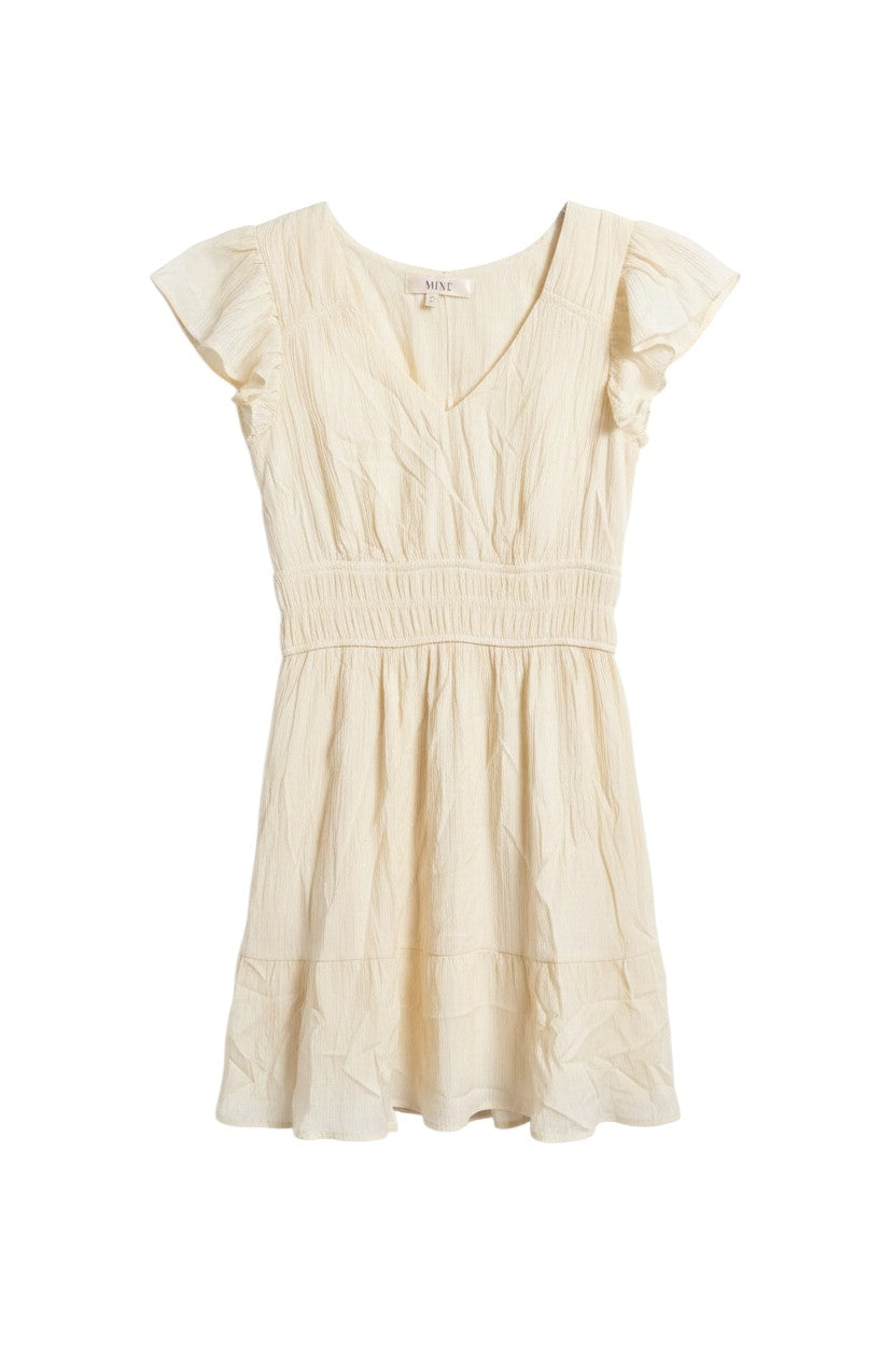 Yanet Collection Shop cream short dress with v-neckline, flutter sleeves, and a tiered skirt in textured fabric.