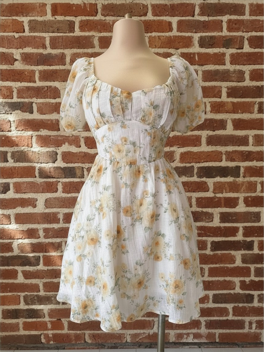 Yanet Collection Shop floral mini dress with short puff sleeves, square neckline, and fitted bodice on a mannequin.