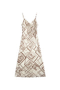 Yanet Collection Shop white maxi dress with brown geometric print, spaghetti straps, and a tie-front detail.