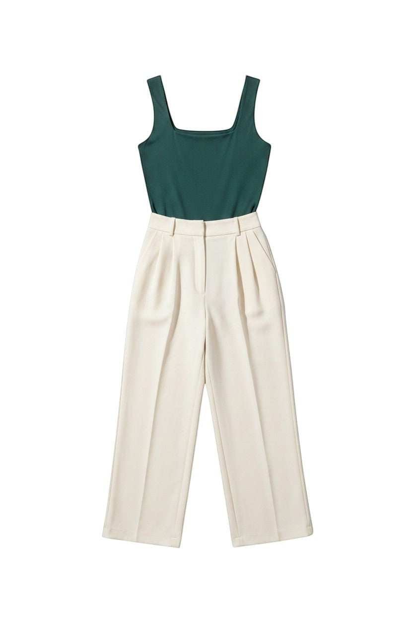 Yanet Collection Shop green sleeveless bodysuit paired with cream high-waisted trousers on a white background