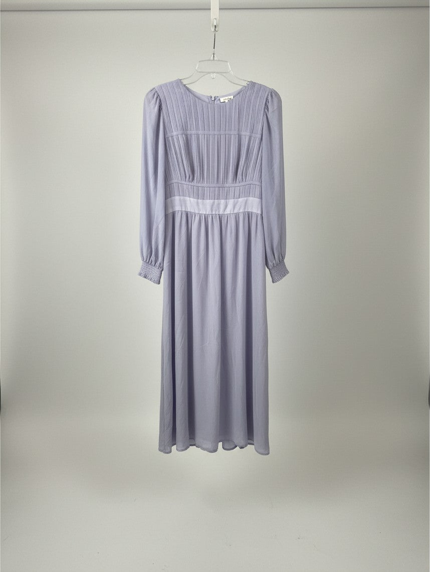 Yanet Collection Shop lavender long sleeve maxi dress with a pleated bodice and fitted waist on a hanger