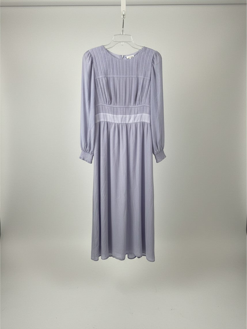 Yanet Collection Shop lavender long sleeve maxi dress with a pleated bodice and fitted waist on a hanger