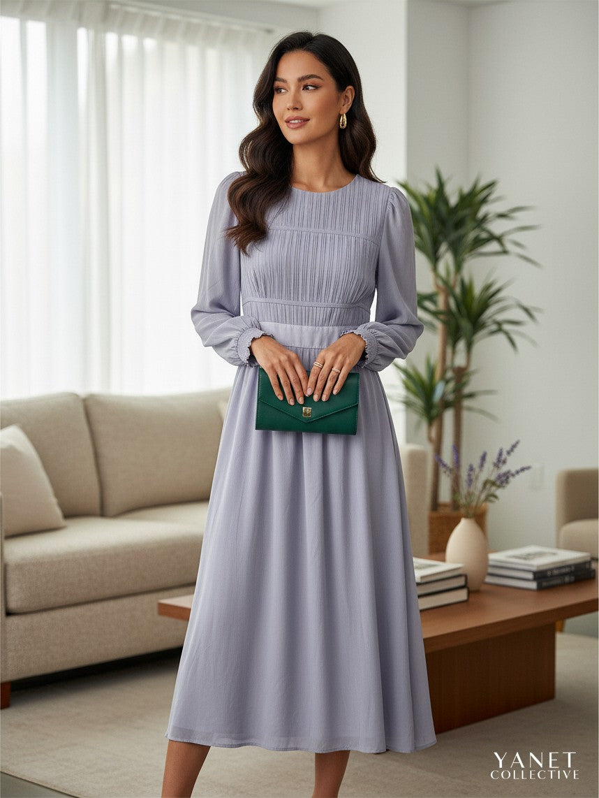 Yanet Collection Shop lavender long sleeve maxi dress with a pleated bodice and flowing skirt worn by a woman