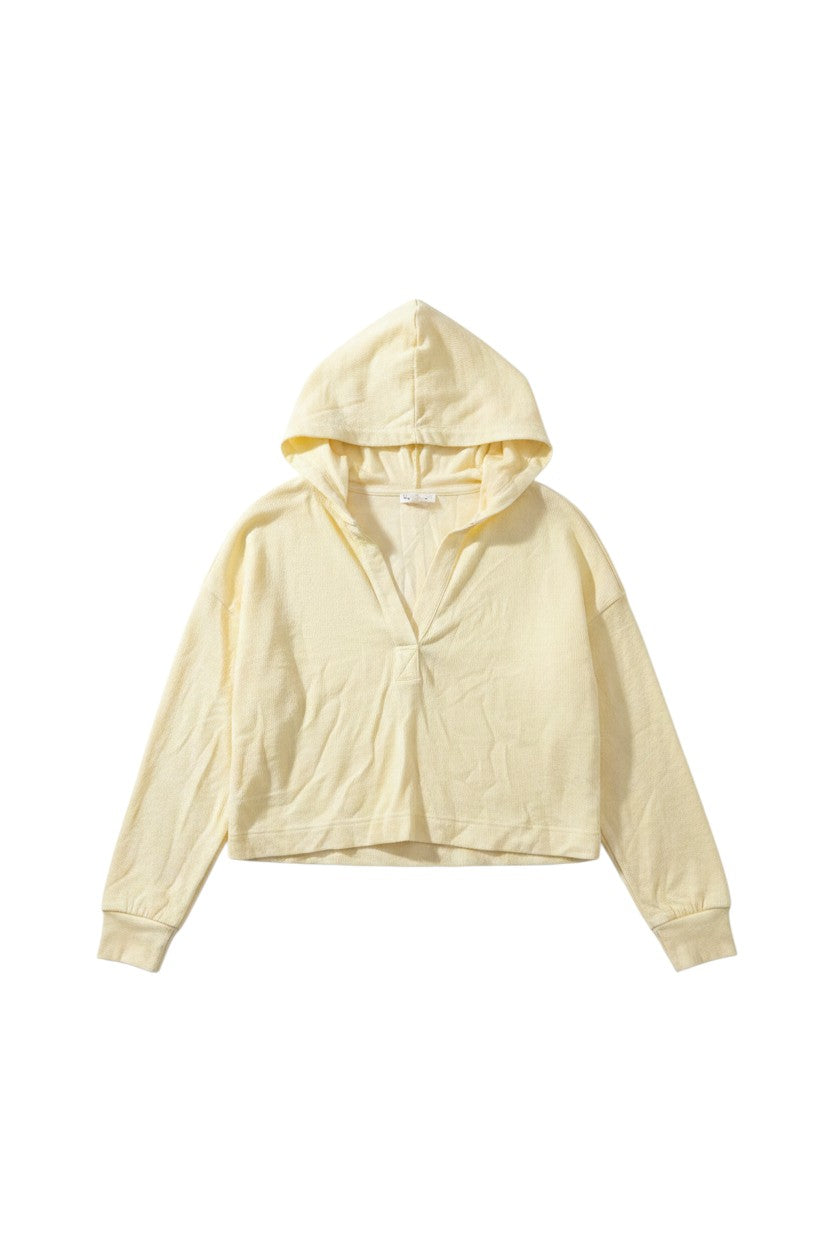 Yanet Collection Shop light yellow long sleeve hoodie with a relaxed fit, v-neckline, and soft textured fabric.