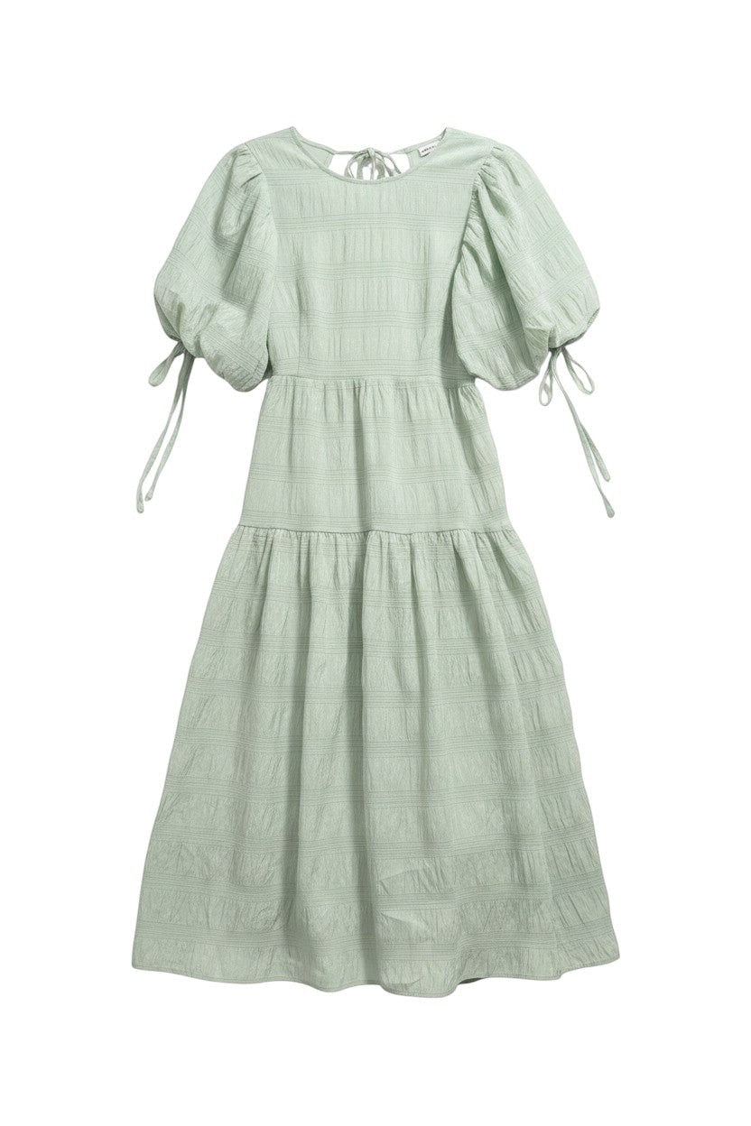 Yanet Collection Shop mint green maxi dress with puff sleeves, tie shoulder details, and a tiered textured skirt.