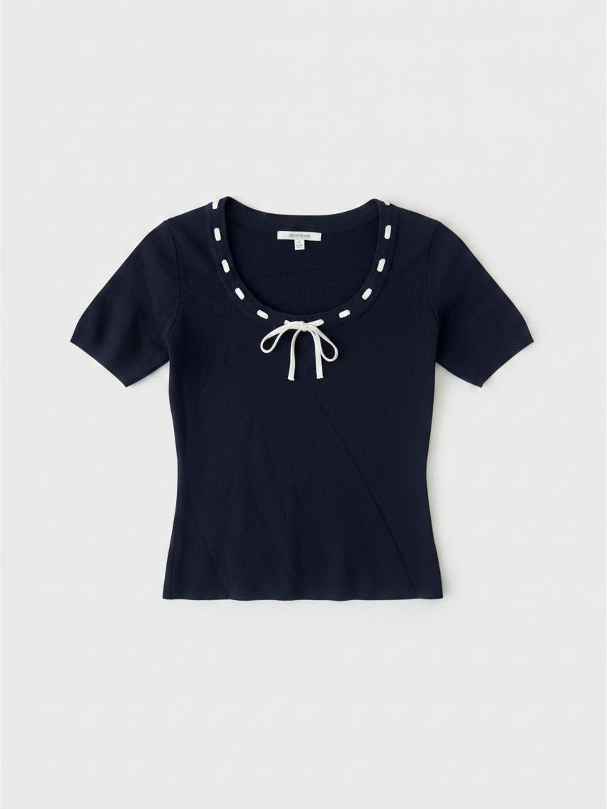 Yanet Collection Shop navy short sleeve fitted top with a round neckline, white stitch detail, and a front tie bow.