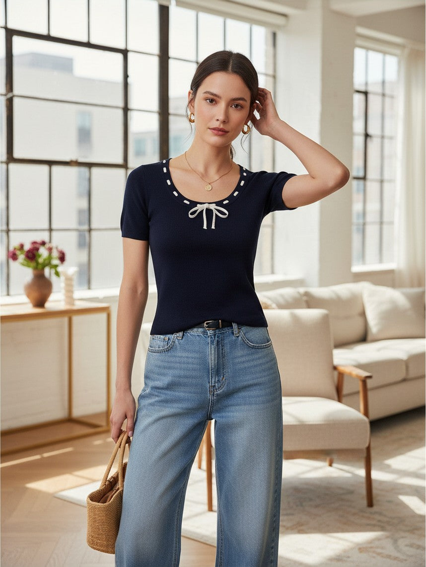 Yanet Collection Shop navy short sleeve top with a round neckline, white decorative tie detail, and fitted silhouette.