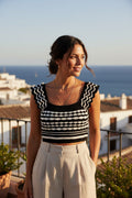 Yanet Collection Shop navy and white sleeveless crop top with scalloped edges and textured knit on a woman outdoors