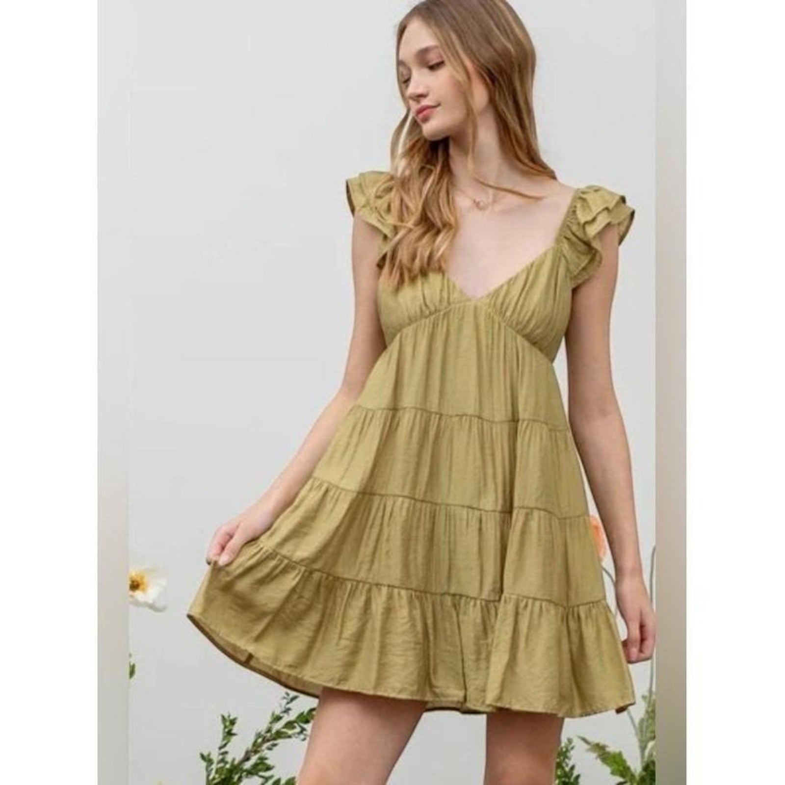 Yanet Collection Shop olive green ruffled tiered mini dress with V-neck and flutter sleeves on a woman blu pepper