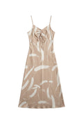 Yanet Collection Shop peach maxi dress with spaghetti straps, tie front detail, and white brushstroke pattern.