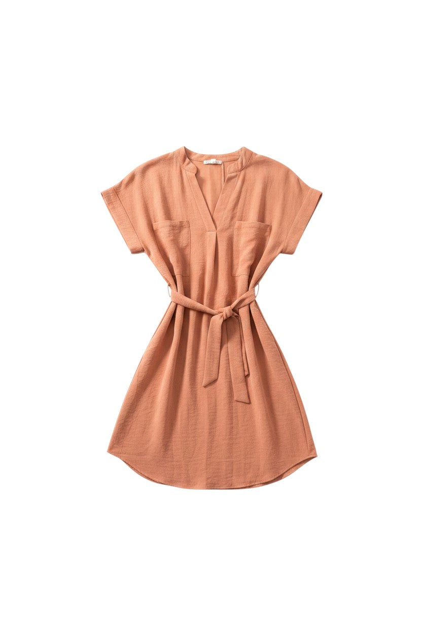 Yanet Collection Shop peach short-sleeve mini dress with a V-neck, chest pockets, and a tie-waist belt.