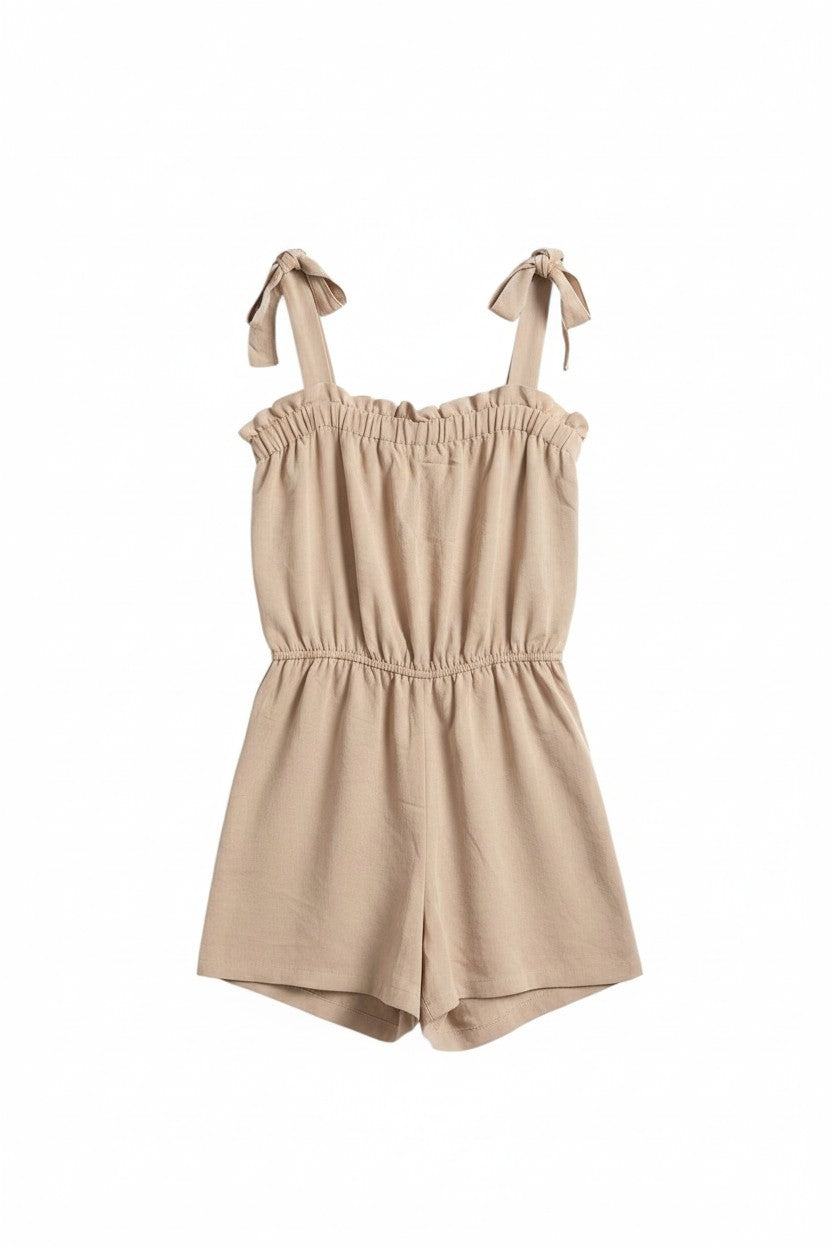 Yanet Collection Shop peach strapless romper with a ruffled neckline, adjustable tie straps, and an elastic waist.