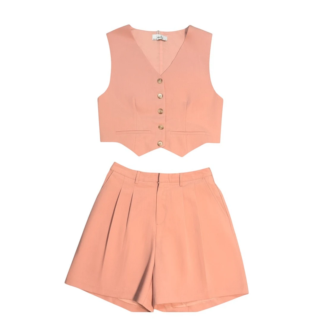 Yanet Collection Shop peach two-piece set featuring a button-up cropped vest and high-waisted pleated shorts.