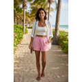 Yanet Collection Shop pink high-waist relaxed fit shorts with side pockets worn by a woman on a tropical beach path.
