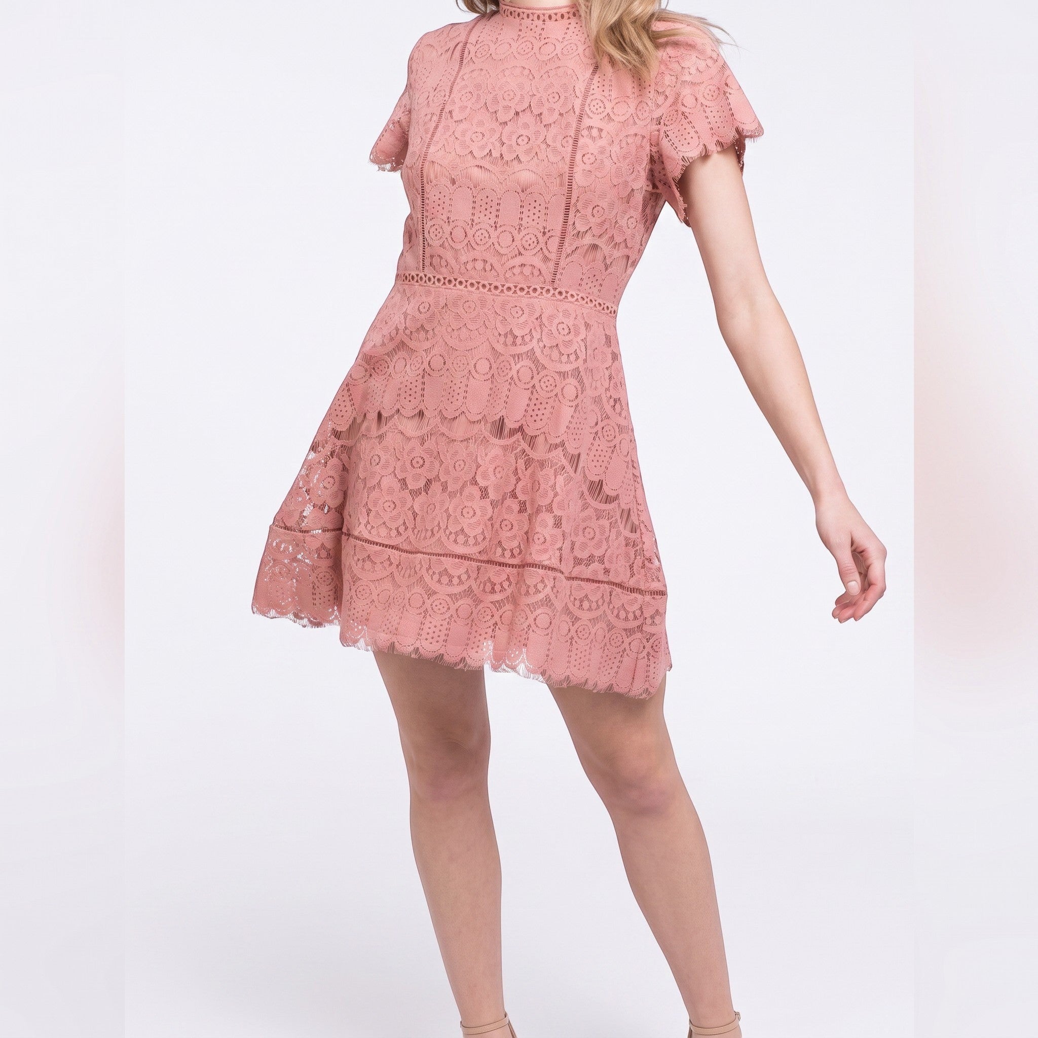 Yanet Collection Shop pink lace short sleeve dress with a fitted silhouette and scalloped hem on a model