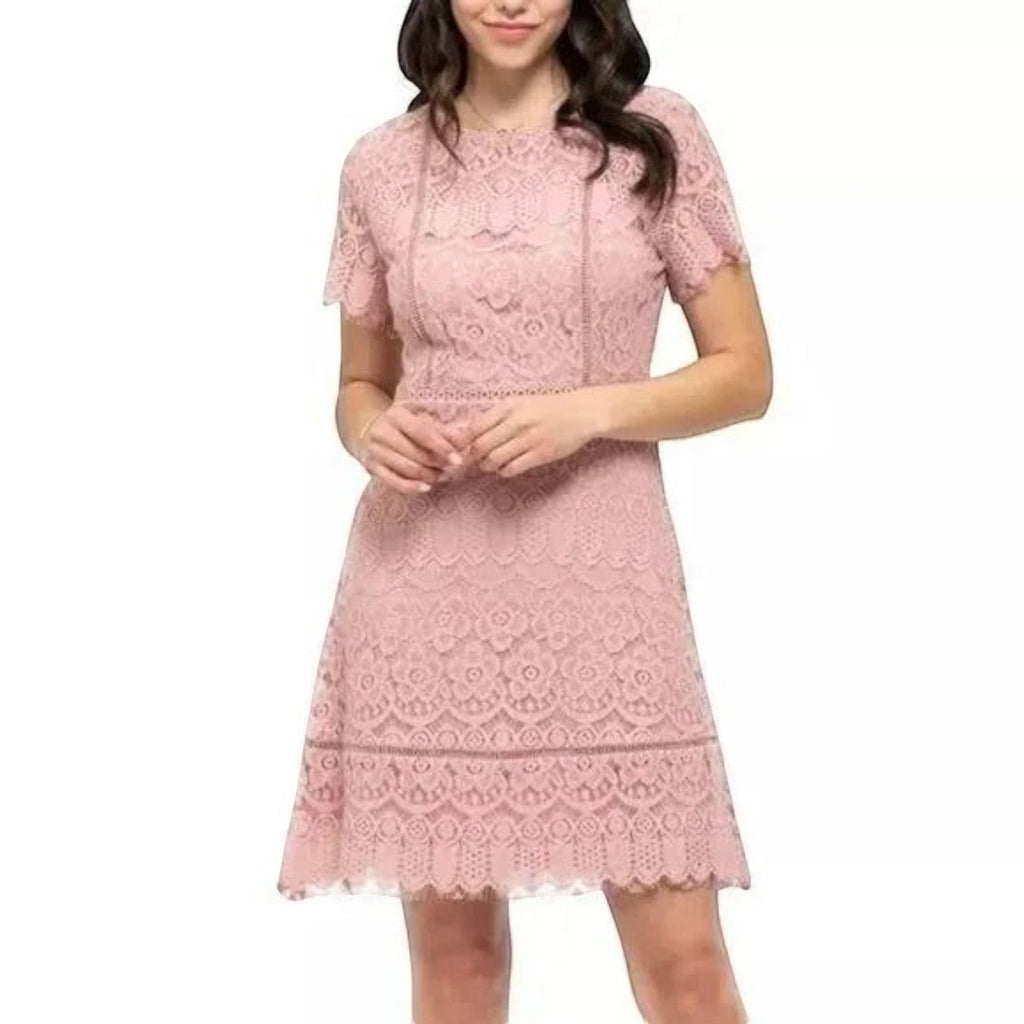 Yanet Collection Shop pink lace knee-length dress with short sleeves and a scalloped hem on a model