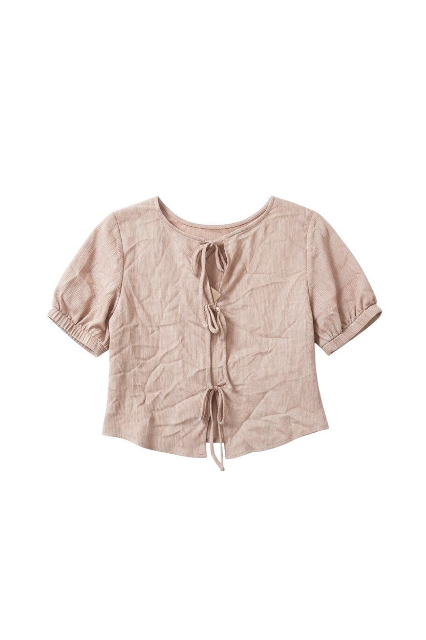 Yanet Collection Shop pink textured short sleeve top with puff sleeves and front tie closure on a white background