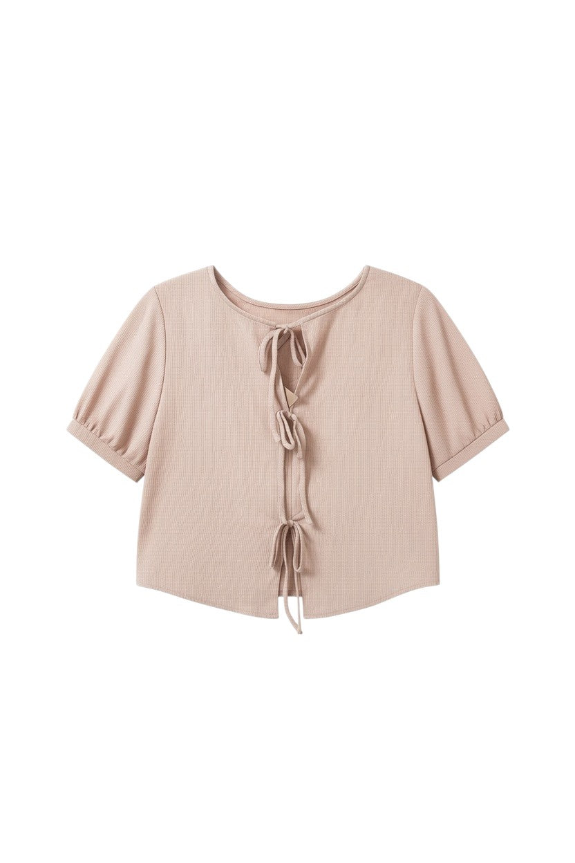 Yanet Collection Shop pink textured short sleeve top with puff sleeves and front tie closure on a white background.
