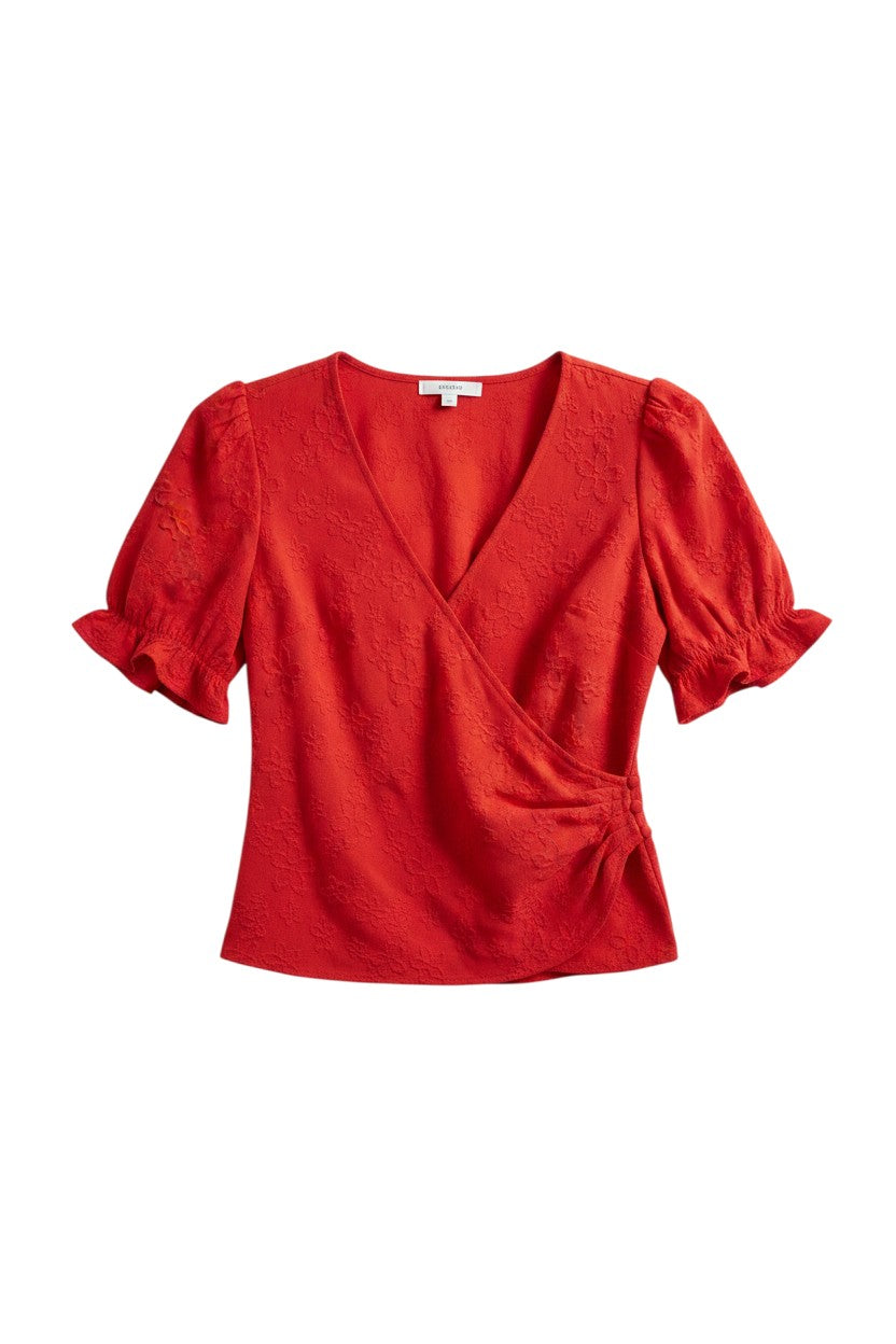 Yanet Collection Shop red wrap top with v-neckline, short ruffle sleeves, and textured floral fabric detail.